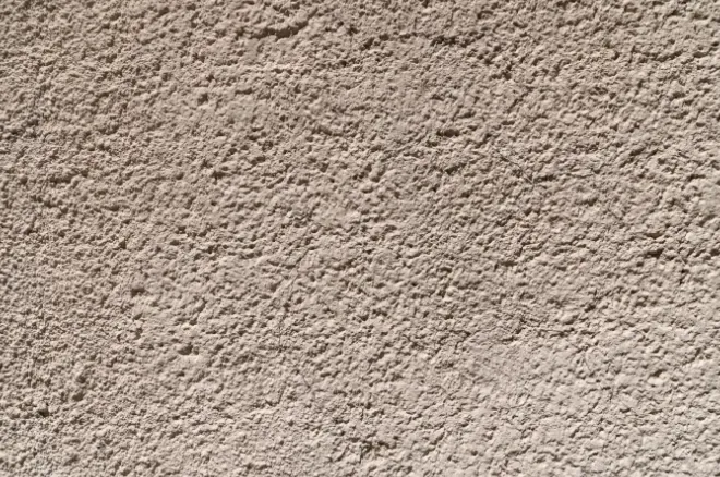 Close up of a textured plaster wall finish in warm beige